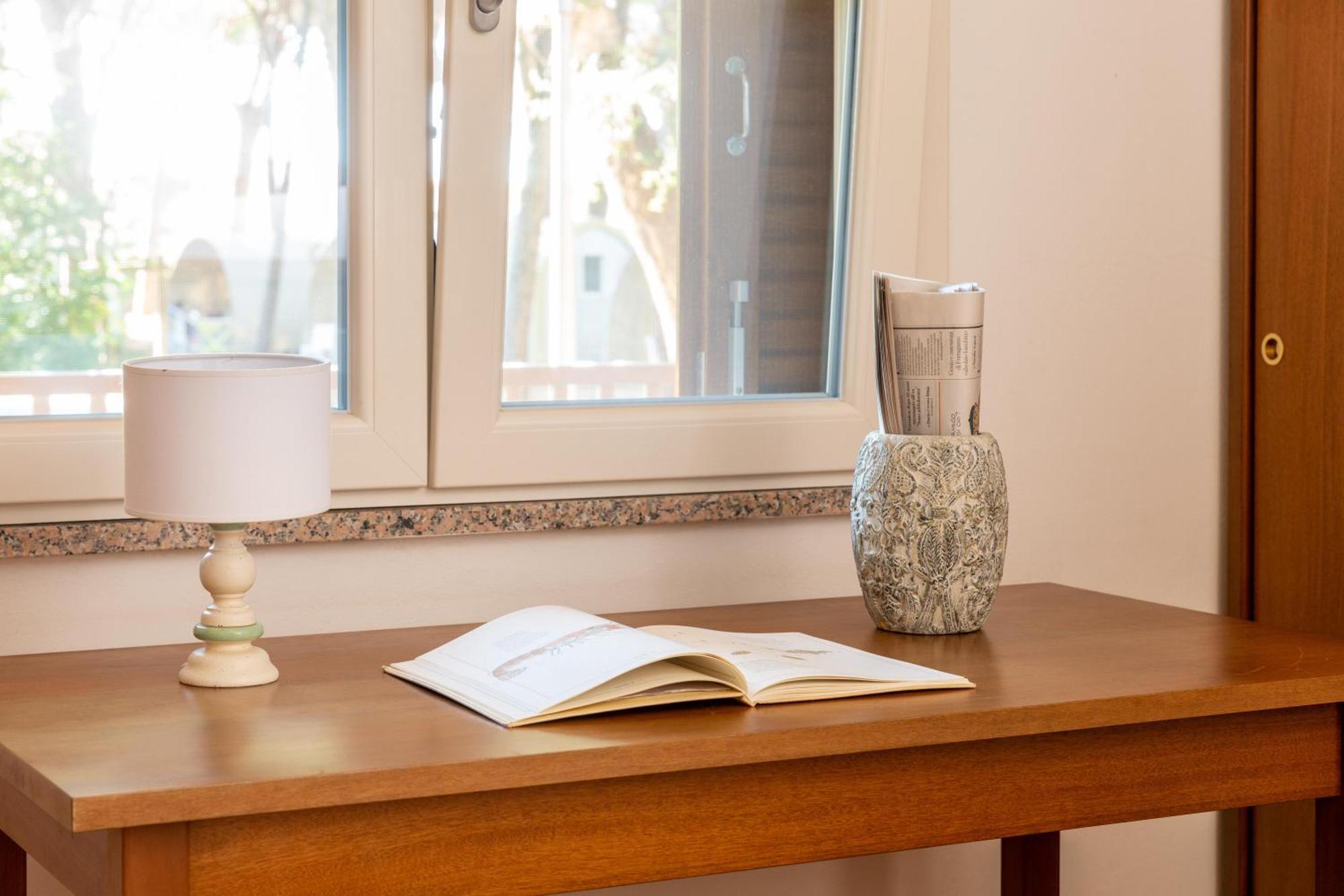 Argentario Camping Village Albinia Esterno foto A table with a lamp and a book